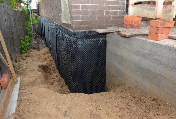 SJ Waterproofing Pros technician performing targeted Wet Basement Repair assessment in Sparta, WI